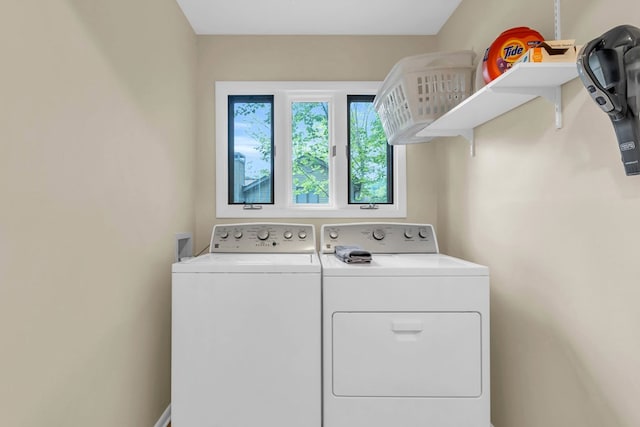 clothes washing area with independent washer and dryer
