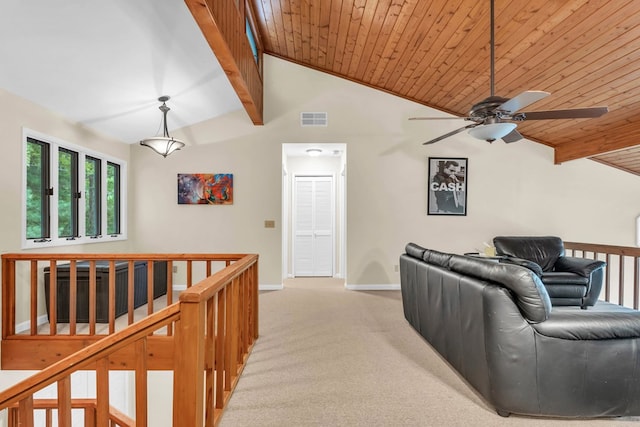 living area with a ceiling fan, light carpet, baseboards, and wooden ceiling