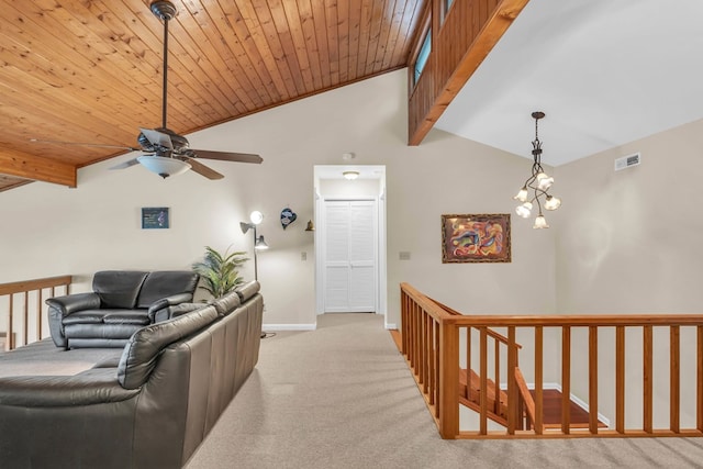 carpeted living room with baseboards, a ceiling fan, and a chandelier