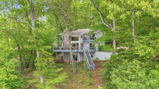 view of front of home with stairway and a deck