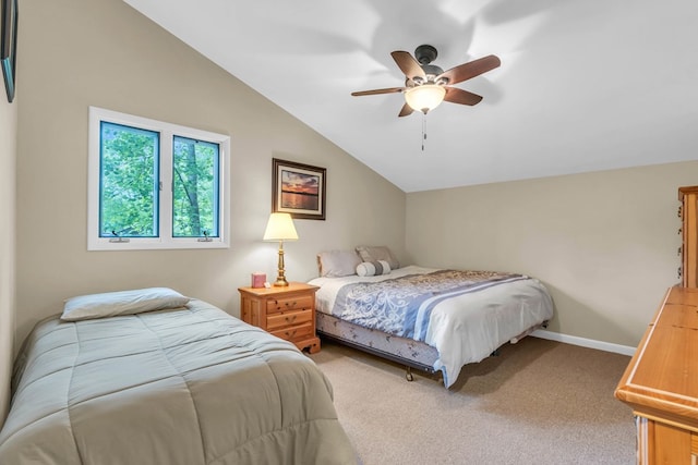 bedroom featuring vaulted ceiling, light colored carpet, baseboards, and a ceiling fan
