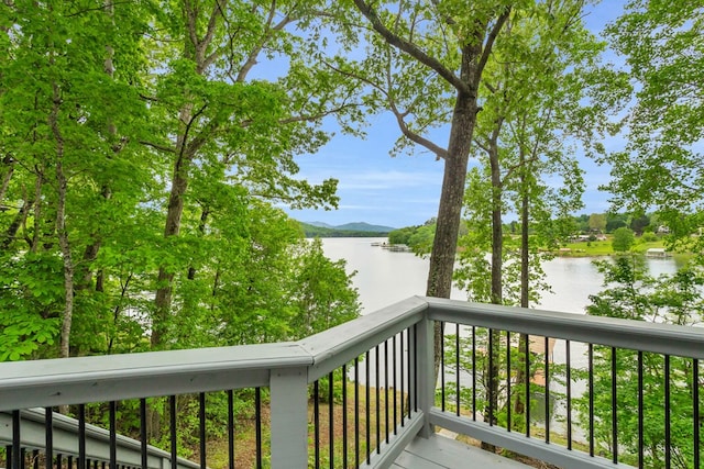 balcony featuring a water and mountain view