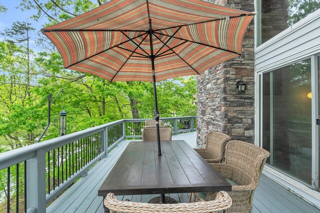 wooden terrace featuring outdoor dining area