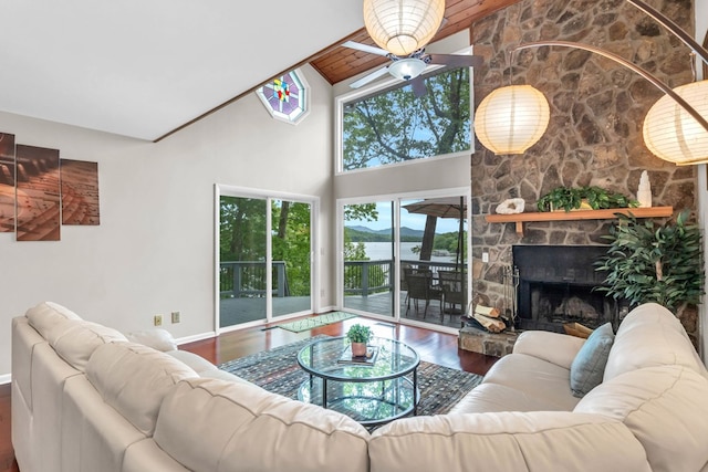 living room with wood finished floors, ceiling fan, high vaulted ceiling, a water view, and baseboards