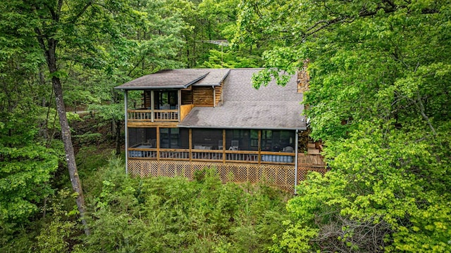 35 The Blf, Morganton, GA 30560 - view of front of property featuring a sunroom, a view of trees, a chimney, roof with shingles, and a balcony