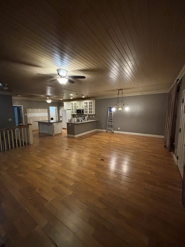 unfurnished living room with baseboards, a ceiling fan, dark wood-style floors, and crown molding