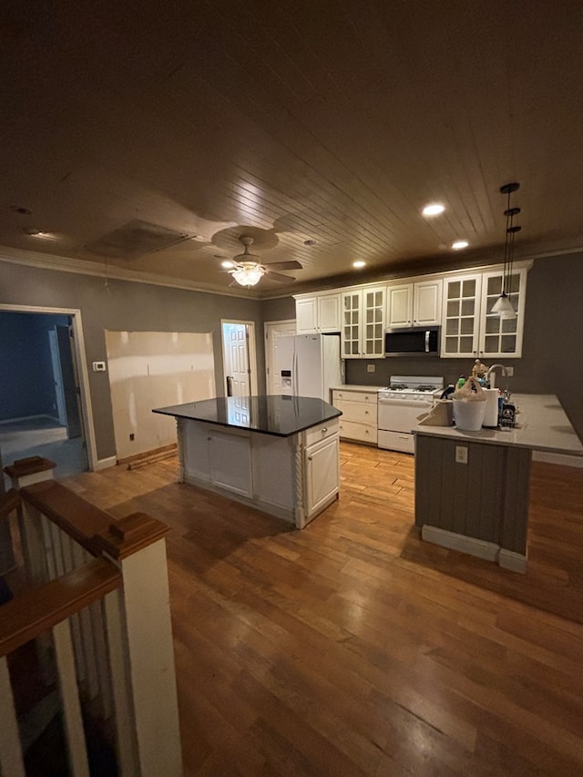 kitchen featuring white appliances, ornamental molding, wood ceiling, glass insert cabinets, and light wood-style floors