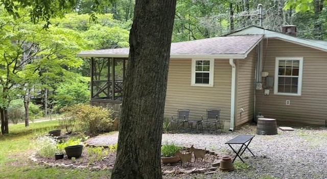 66 Patterson Ln, Hayesville, NC 28904 - view of home's exterior featuring roof with shingles and a sunroom