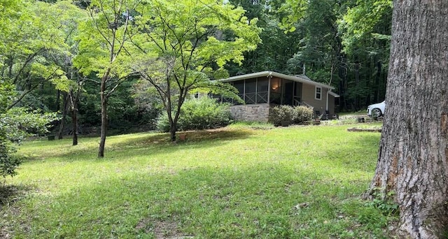 66 Patterson Ln, Hayesville, NC 28904 - view of green lawn featuring a sunroom and a wooded view