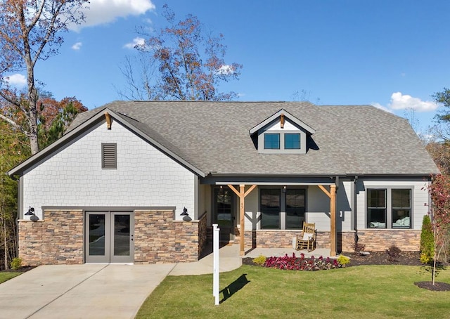 view of front of property with a front lawn, french doors, and a porch