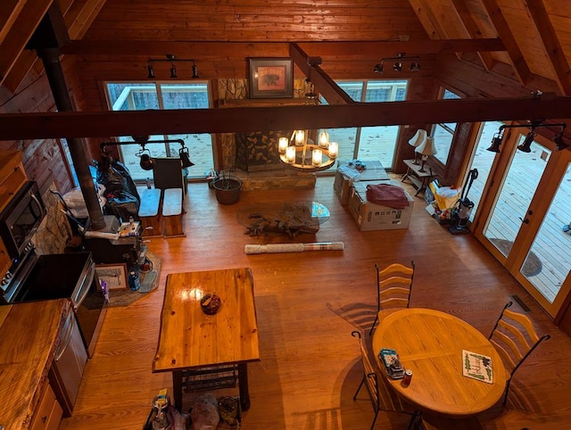 dining room with wood ceiling, beam ceiling, high vaulted ceiling, and light hardwood / wood-style flooring