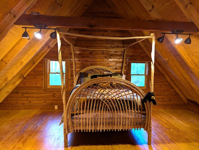 bedroom with wood ceiling, wood-type flooring, log walls, and lofted ceiling with beams