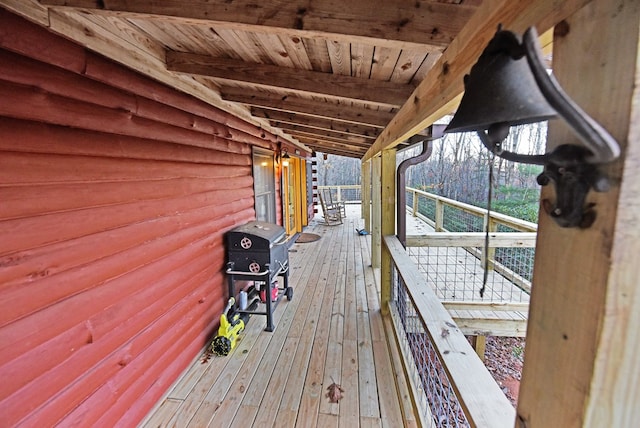 wooden deck featuring a grill