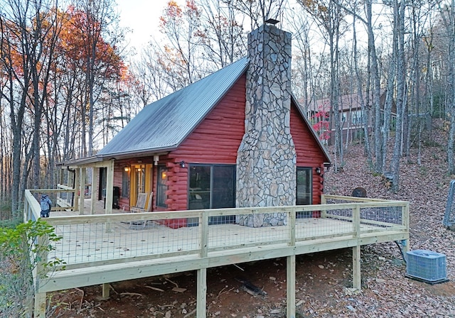 back of property featuring a wooden deck and cooling unit