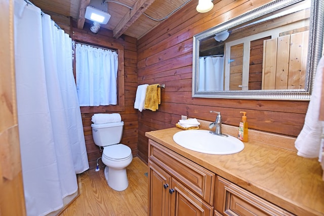 bathroom featuring wood ceiling, hardwood / wood-style flooring, beam ceiling, wooden walls, and toilet