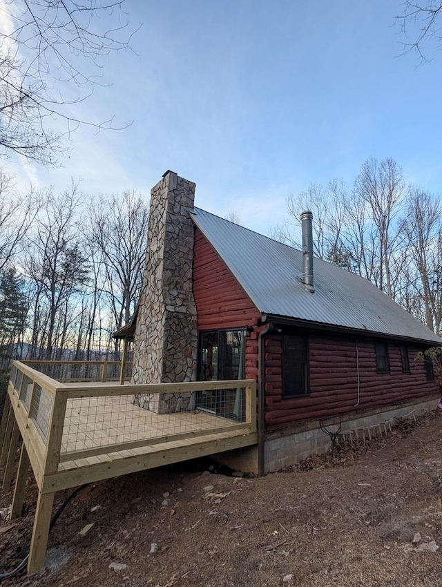 rear view of property with a wooden deck