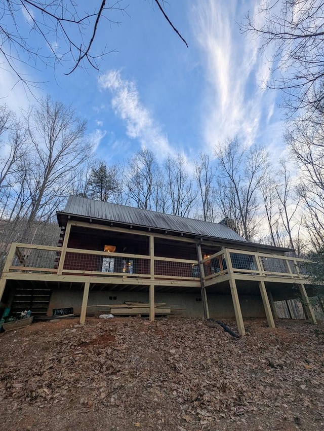 back of house featuring a wooden deck