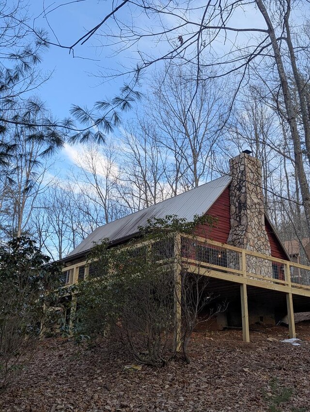 view of property exterior featuring a wooden deck