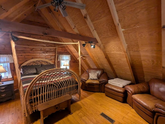 bedroom featuring vaulted ceiling with beams, wood ceiling, and light wood-type flooring