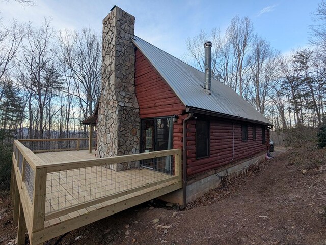 view of side of property with a wooden deck