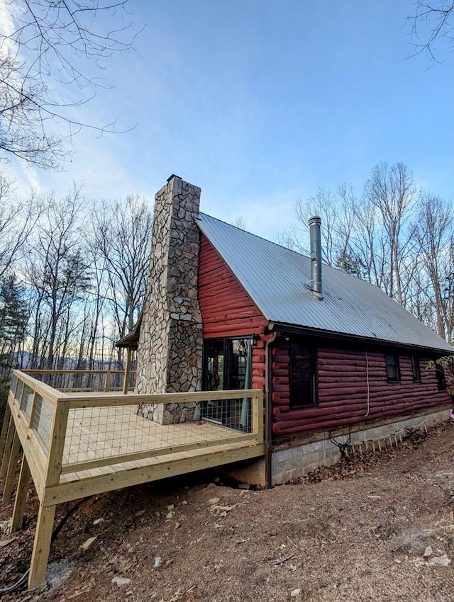 view of home's exterior with a wooden deck