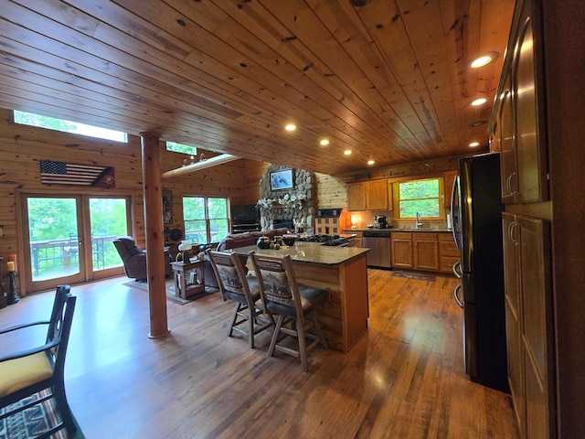 1102 Summit Way, Blairsville, GA 30512 - kitchen featuring stainless steel dishwasher, freestanding refrigerator, light wood-style flooring, ornate columns, and dark countertops