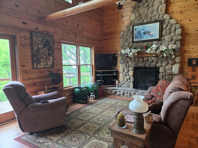 1102 Summit Way, Blairsville, GA 30512 - living room with wood finished floors, wood walls, healthy amount of natural light, and a stone fireplace