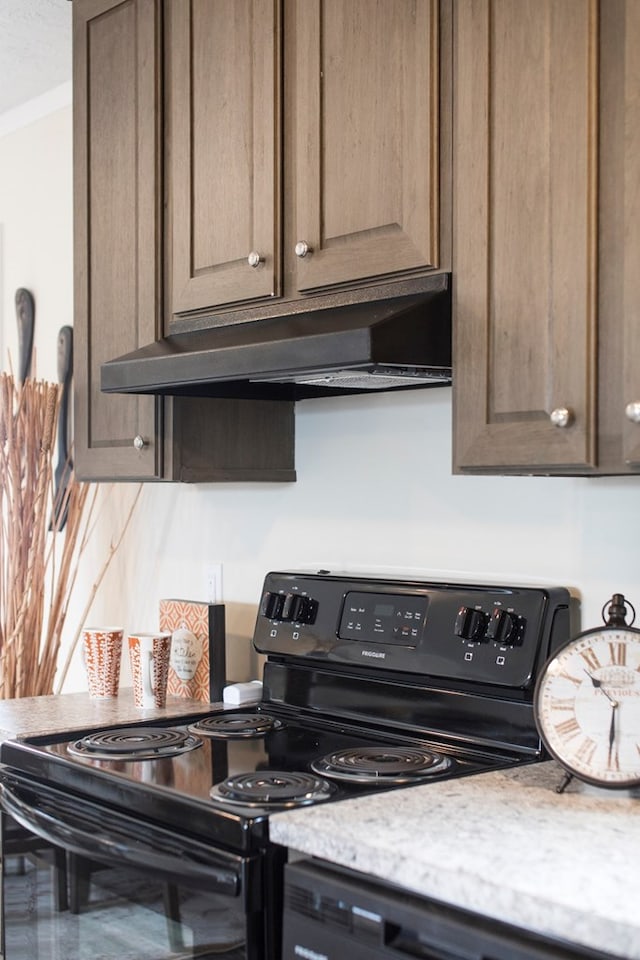 kitchen with under cabinet range hood, electric range, and light stone countertops
