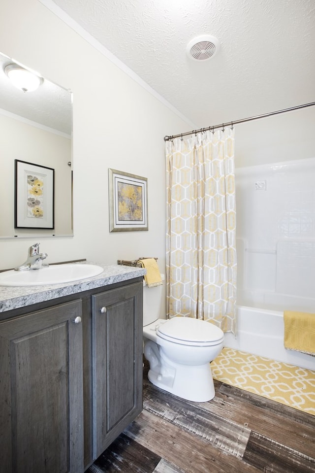 full bathroom featuring crown molding, vanity, toilet, wood finished floors, and visible vents