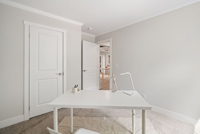 office space with baseboards, ornamental molding, and carpet
