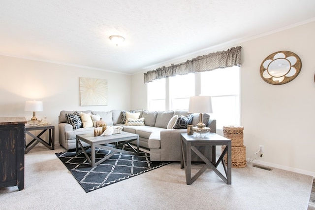 carpeted living room with baseboards, visible vents, and ornamental molding