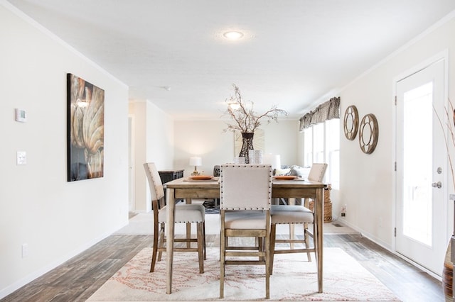 dining space featuring baseboards and wood finished floors
