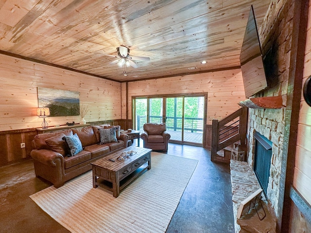 340 Hooch Holler Ln, Morganton, GA 30560 - living room featuring wooden ceiling, finished concrete floors, wood walls, a ceiling fan, and a fireplace