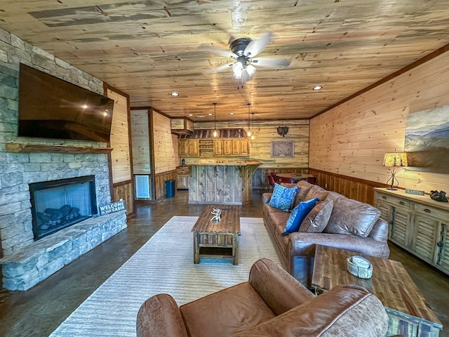 340 Hooch Holler Ln, Morganton, GA 30560 - living room featuring wooden walls, ceiling fan, wooden ceiling, finished concrete flooring, and a fireplace