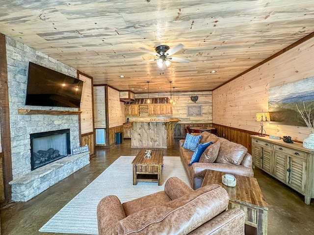 340 Hooch Holler Ln, Morganton, GA 30560 - living area with wood walls, finished concrete floors, wood ceiling, ceiling fan, and a stone fireplace