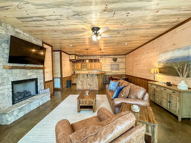 340 Hooch Holler Ln, Morganton, GA 30560 - living area with wood walls, finished concrete floors, ceiling fan, wooden ceiling, and a stone fireplace