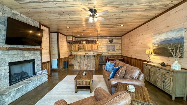 340 Hooch Holler Ln, Morganton, GA 30560 - living room with wood walls, wood ceiling, a ceiling fan, a stone fireplace, and finished concrete floors