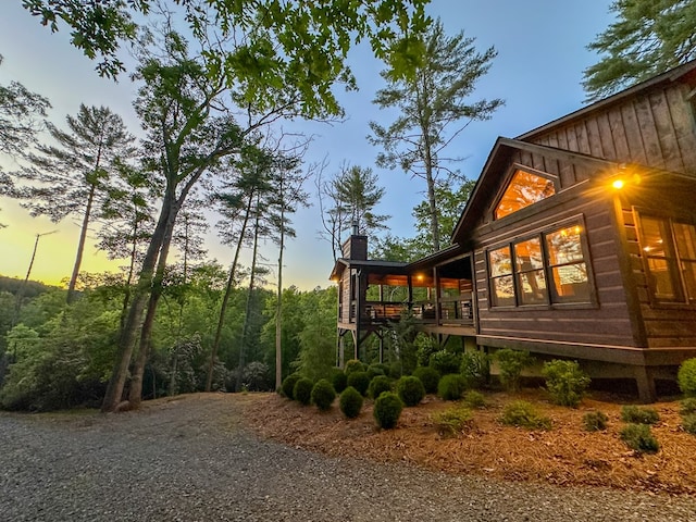 340 Hooch Holler Ln, Morganton, GA 30560 - property exterior at dusk with a chimney and board and batten siding
