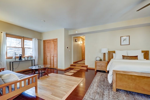 bedroom featuring a closet, baseboards, and hardwood / wood-style floors