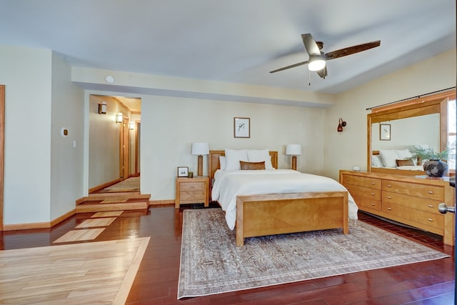 bedroom with wood finished floors, a ceiling fan, and baseboards