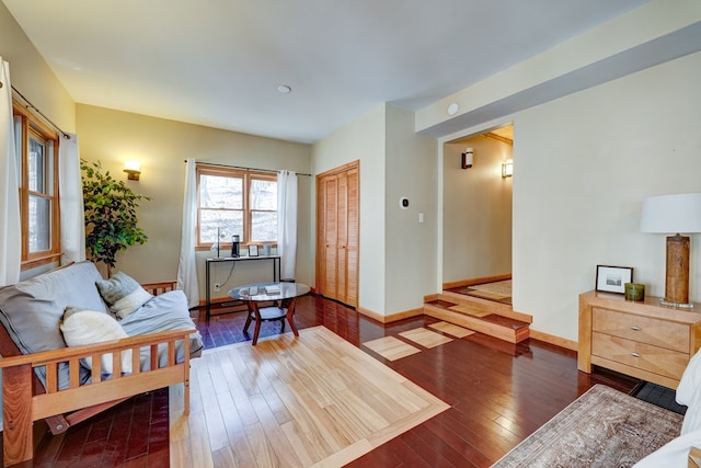 living area featuring baseboards and hardwood / wood-style floors