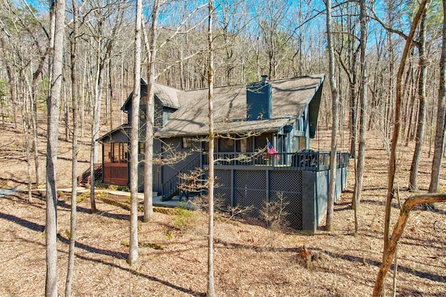 rear view of house with a deck and stairs