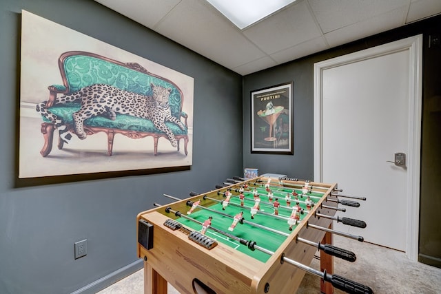 rec room with a paneled ceiling and carpet flooring