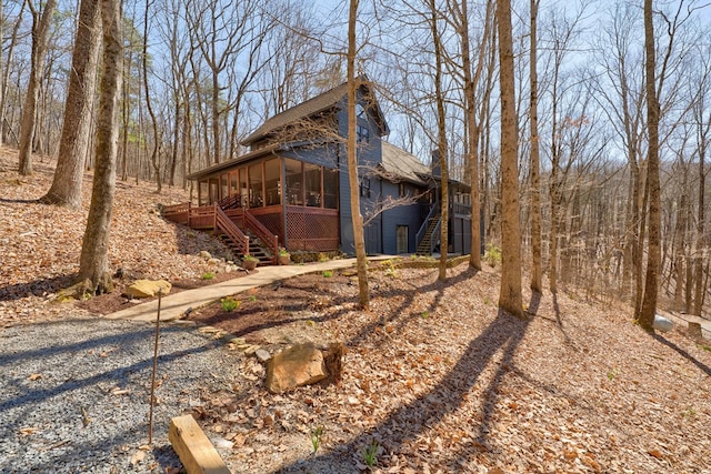 view of yard featuring a sunroom and stairs