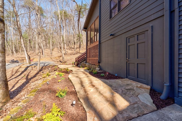 view of side of property with stairway