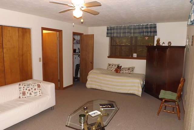 bedroom with carpet floors, a textured ceiling, and ceiling fan