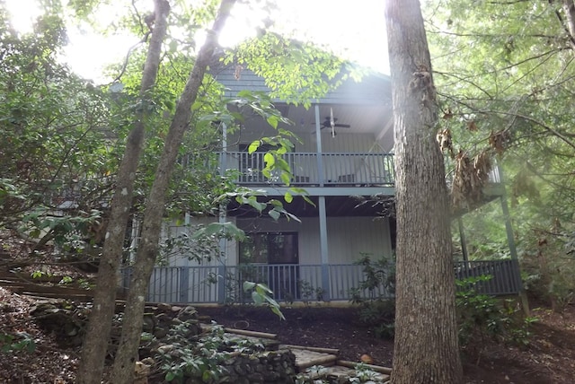 back of house featuring a balcony