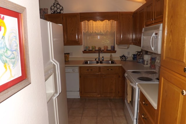 kitchen featuring sink, tile patterned flooring, and white appliances