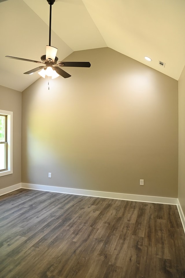 empty room featuring ceiling fan, dark hardwood / wood-style floors, and vaulted ceiling