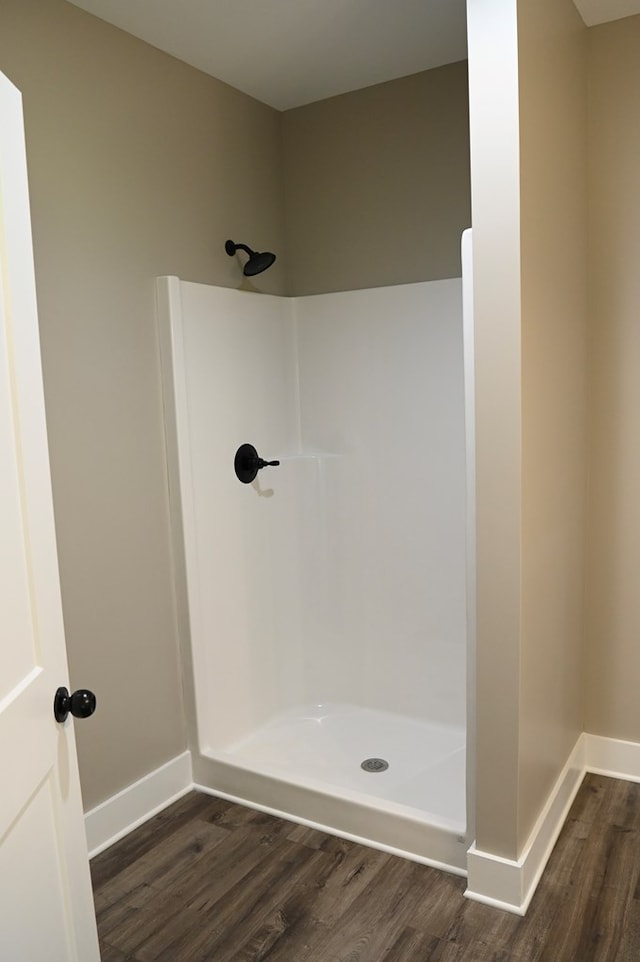 bathroom featuring wood-type flooring and a shower